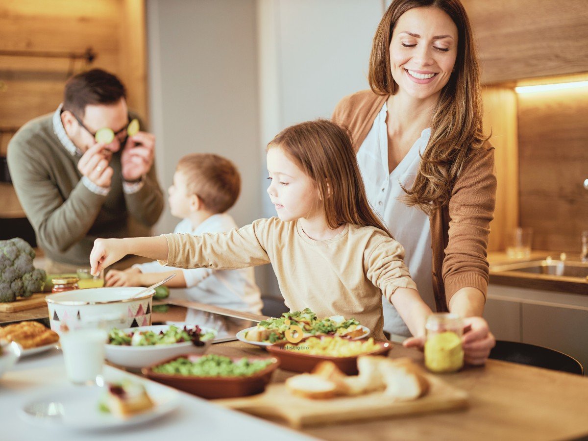 Happy family preparing and enjoying a healthy meal together, representing nutrition, metabolic health, and food-based longevity.